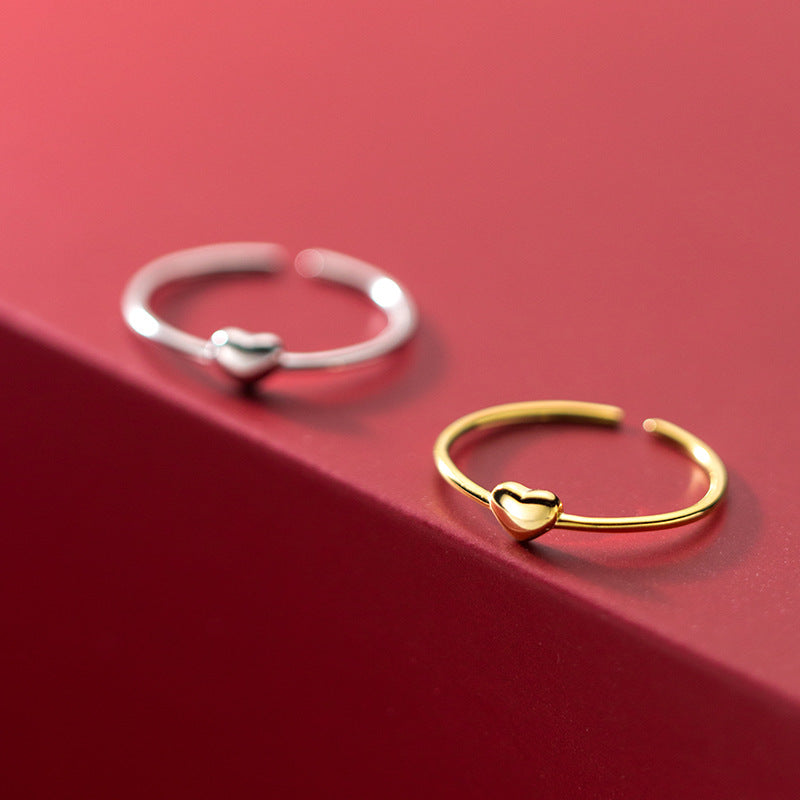 A set of 925 sterling silver minimalist love heart opening finger rings, shown in both gold and silver finishes.