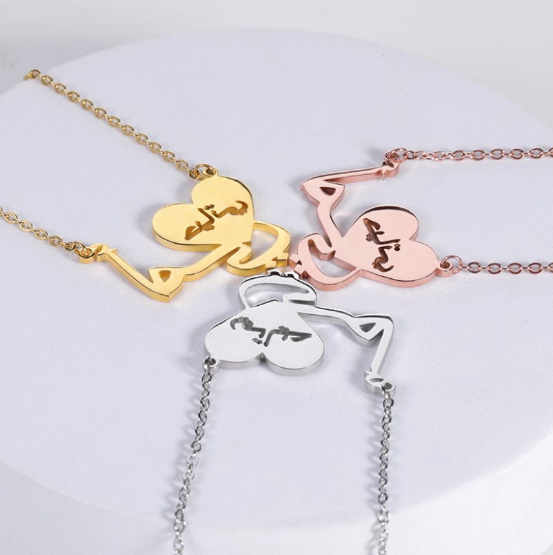 Three custom Arabic heart necklaces displayed side-by-side in gold, rose gold, and silver finishes, showcasing the available plating options.