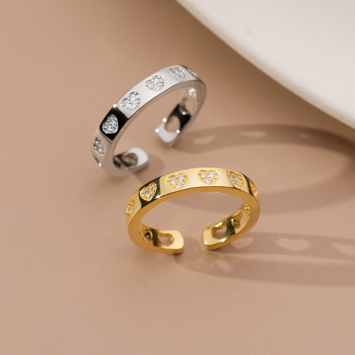 A set of 925 sterling silver love heart open rings, showcasing both the elegant gold and classic silver finishes.