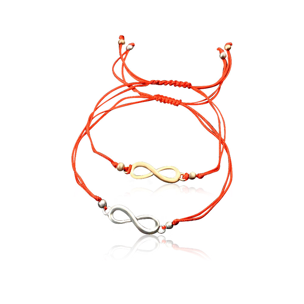 Close-up of two Infinity Cord Bracelets, one gold-plated and one silver-plated, on vibrant red cords, symbolizing eternal love.