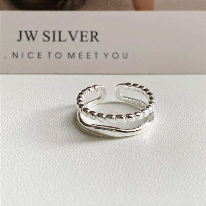 A 925 sterling silver double band adjustable ring with a unique twisted chain design, shown on a clean white background.