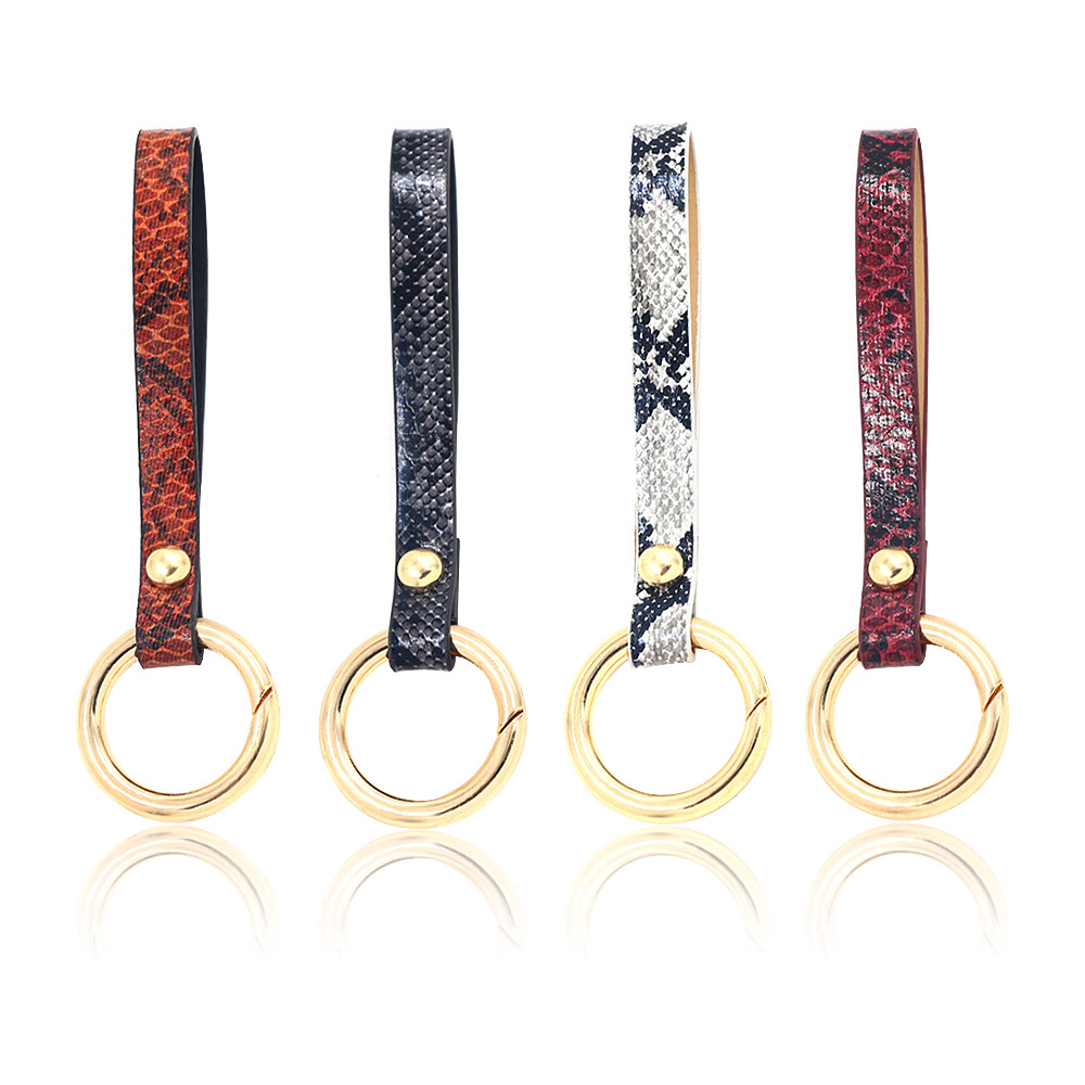 Four PU leather wrist bag handle key rings in different colors, each with a polished gold key ring. Model JRK-003, a versatile fashion accessory.