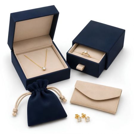 Premium jewelry packaging set with navy blue magnetic box, sliding drawer box, velvet pouch, and envelope pouch.