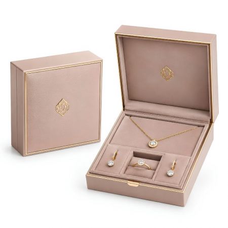 Luxury pink leather jewelry gift box with gold trim inlay and a matching 3-piece insert for fine jewelry sets.