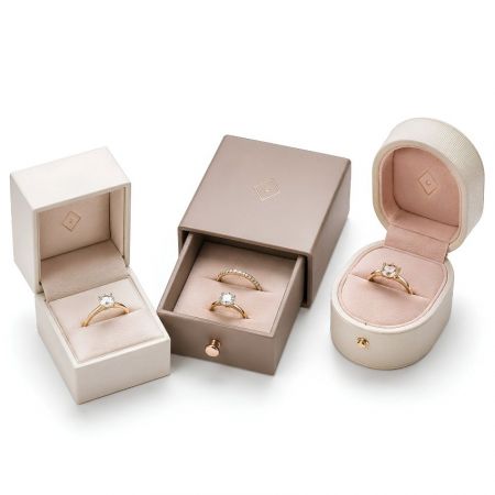 Premium wholesale ring boxes including a square hinged box, a sliding drawer box, and an oval velvet presentation box.