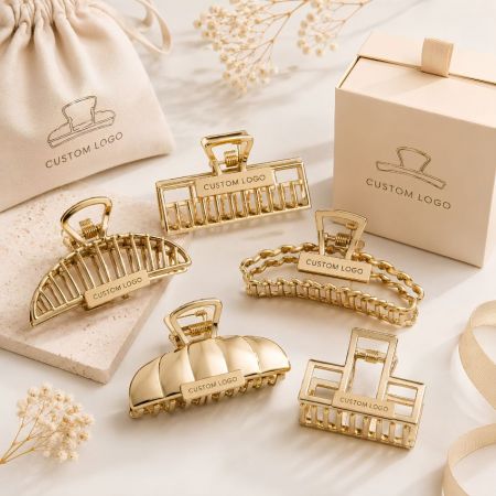 Bulk hollow-out gold metal claw clips with custom brand logos for fashion retailers and e-commerce sellers.