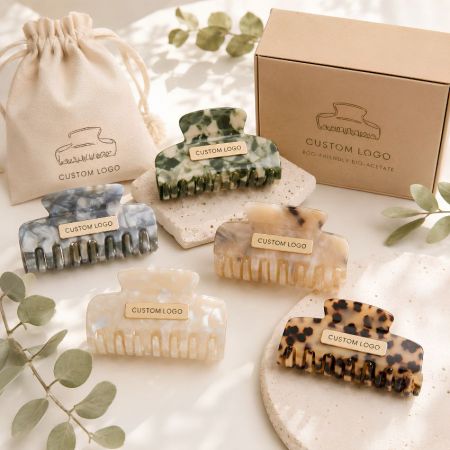 Eco-friendly bio-acetate claw clips in marble and tortoiseshell patterns with custom private label packaging.