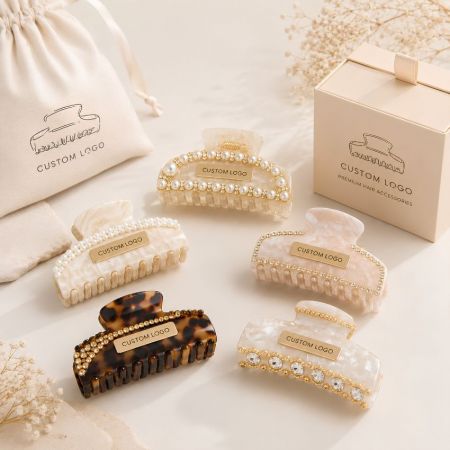 Premium pearl and rhinestone embellished acetate claw clips with custom logos for luxury hair accessory brands.