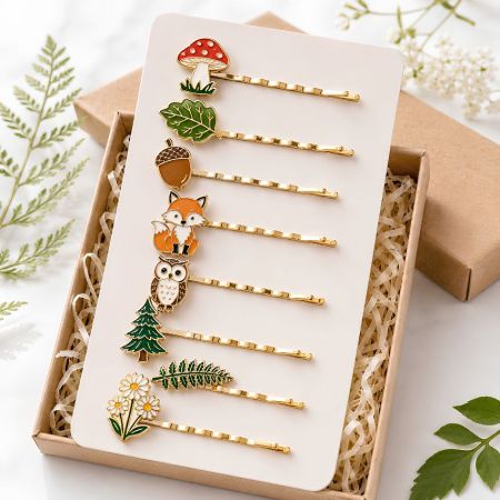 Autumn forest style bobby pins with custom fox, owl, mushroom, and leaf enamel charms in a kraft paper gift box.