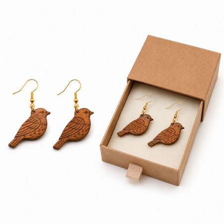Bird-shaped engraved wooden drop earrings displayed with custom cardboard gift packaging for boutique retailers.
