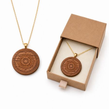 Intricate tribal circular engraved wood pendant necklace on gold-toned chain with premium retail slide-out box.