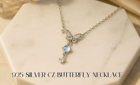 Close-up detail of the CZ butterfly necklace on a marble surface, highlighting the 925 silver craftsmanship.