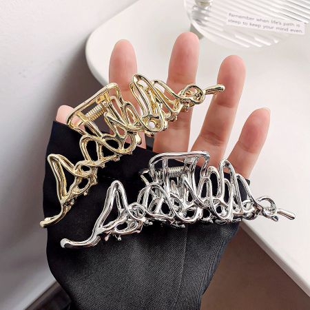 Metal Alloy Hollow Geometric Hair Claw Clips (Set of 5) - A set of metal alloy hollow geometric hair claw clips, showcasing both the gold and silver finishes held by a gloved hand.