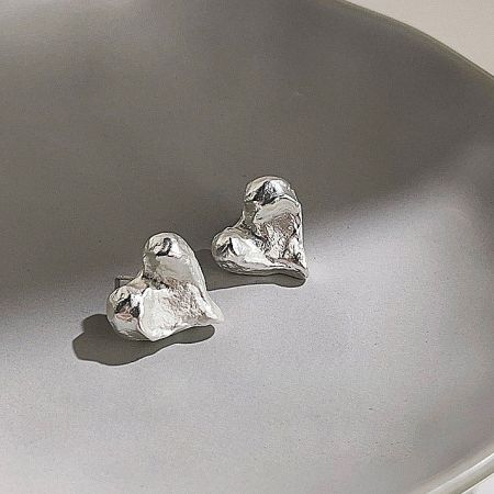 A pair of unique silver earrings with an abstract, artistic heart design.