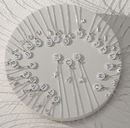 The complete alphabet set of the initial coin necklaces in sterling silver with cubic zirconia.