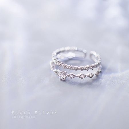 A pair of elegant S925 silver flower lace rings displayed to show their detailed craftsmanship.