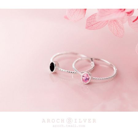 An alternative view showcasing the two sterling silver rings with different colored gemstones.