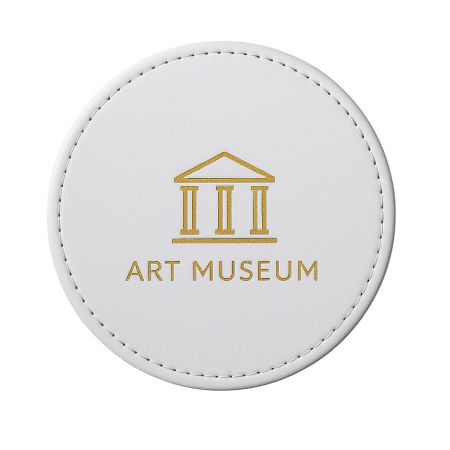 Custom Leather Coasters - A custom brown leather coaster featuring the debossed logo of an art museum, showcasing a premium promotional gift option.