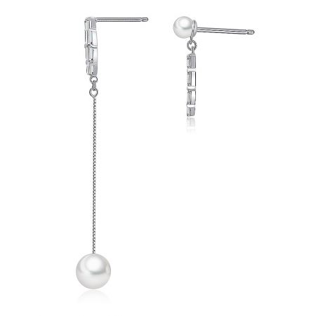 Close-up view showing the asymmetrical design of the pearl and cubic zirconia earrings, with one longer than the other.