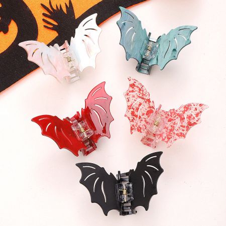 An assortment of colorful bat-shaped hair clips for Halloween.