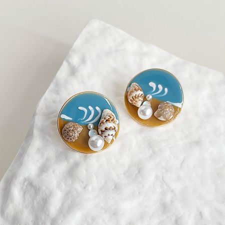 Summer Style Beach Jewelry Gold Plated Enamel Natural Conch Round Stud Earrings (5 pairs) - A set of five pairs of summer style beach-themed stud earrings with seashells, pearls, and gold plating, displayed on a sandy background.