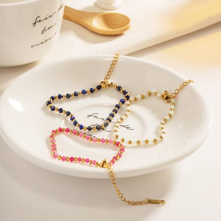 A stylish arrangement of three beaded bracelets on a decorative plate, highlighting their intricate details.