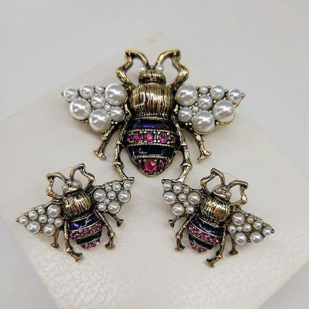 The complete Galaxy Memory Collection bee jewelry set, featuring three distinct pieces including brooches and pendants.