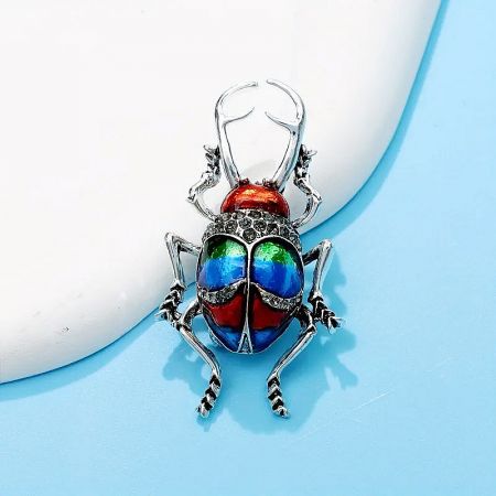 Detailed shot of the beetle pendant's enamel work and craftsmanship.