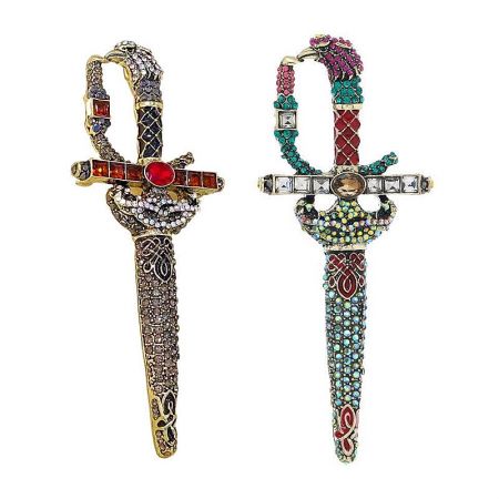 A pair of stunning, jewel-encrusted sword brooches with intricate designs and vibrant gemstones.