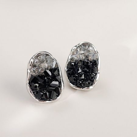 Close-up view of the two-tone clear and black stones in a silver setting.