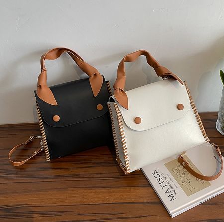 The PU leather handbag JRP-043 shown in both black and white color options.