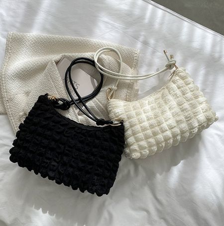 Black and white versions of the cloudy pattern shoulder bag side-by-side