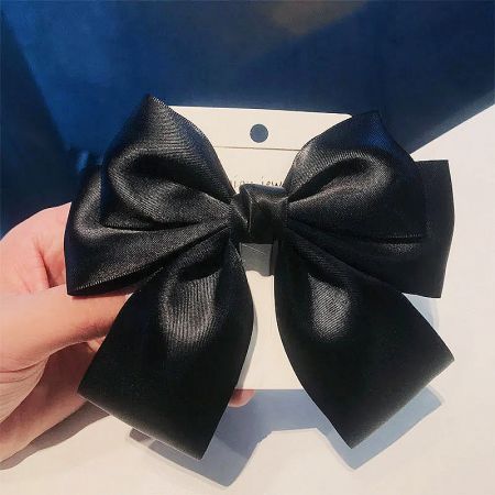 Close-up of the black satin vintage bowknot hair clip.