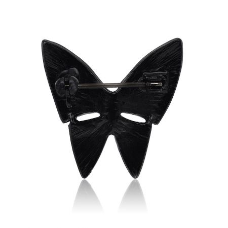 Detailed view of the black butterfly brooch showing the glossy hematite plating and roller pin catch closure.