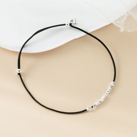 The minimalist black cord bracelet with polished sterling silver beads, perfect for everyday wear.