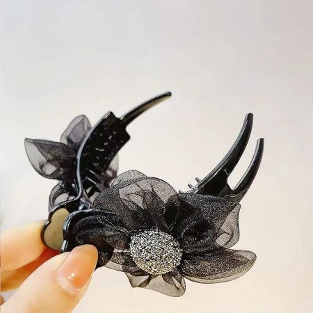 Detailed view of the elegant black mesh flower hair clips.