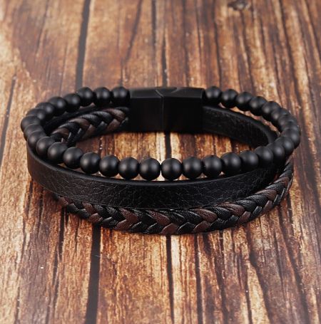 A collection of black leather and beaded bracelets, showcasing men's fashion accessories.