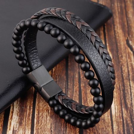 Detailed view of the black leather bracelet showing the braided design and matte black beads.