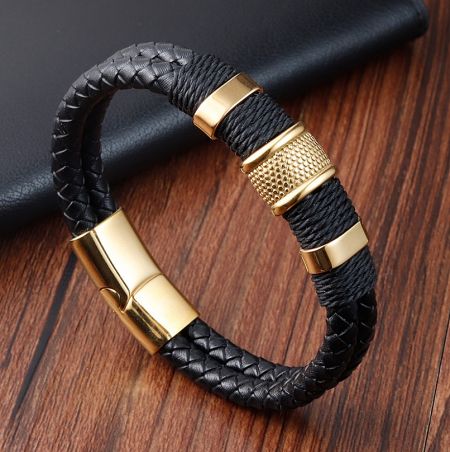 Close-up of the black leather bracelet with a striking gold-plated stainless steel clasp.