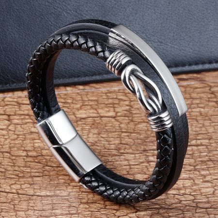 Side view of the men's stainless steel and leather bracelet, highlighting the intricate weave and metal accents.