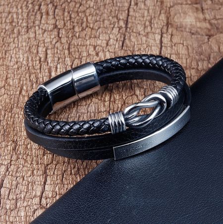 Detailed shot of the clasp mechanism on the men's black leather and stainless steel bracelet.