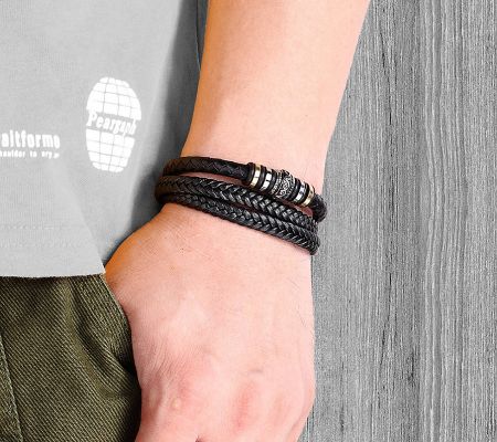 A man wearing the stylish black leather multilayer braided bracelet.