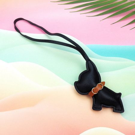 A sleek black leather French Bulldog pouch with a brown collar detail.