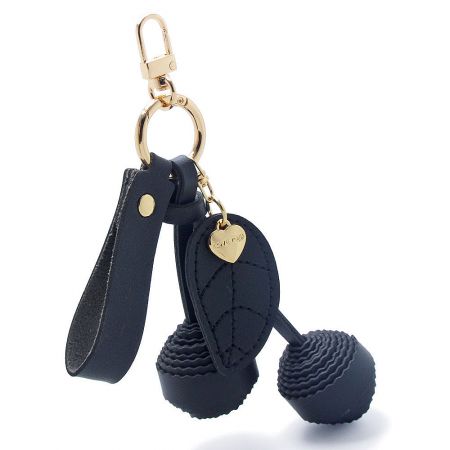 The black PU leather cherry keychain with detailed stitching and gold hardware.
