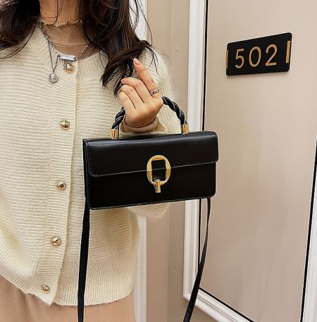 A close-up of the black version of the Female Classic Retro Bag, showcasing the texture and gold clasp detail.