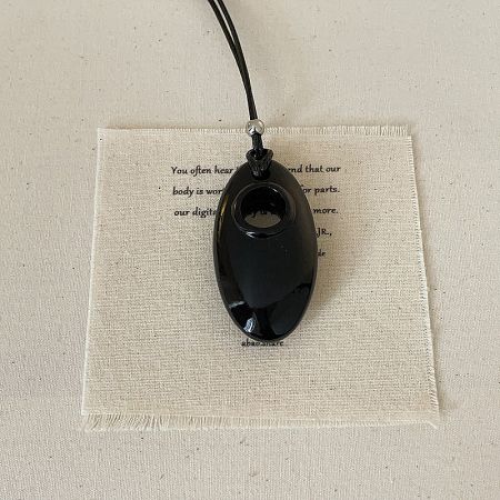 The black oval pendant variation of the minimalist cord necklace collection.