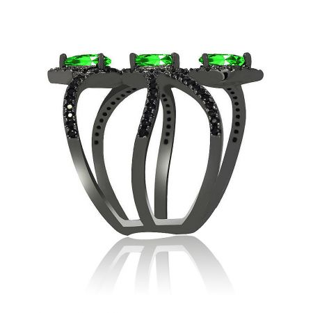 Top-down view of the black hematite ring with three prominent green gemstones.