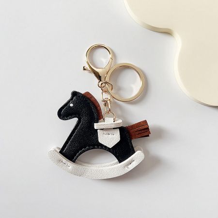 The classic black and white PU leather pony keychain, a versatile accessory for any bag.