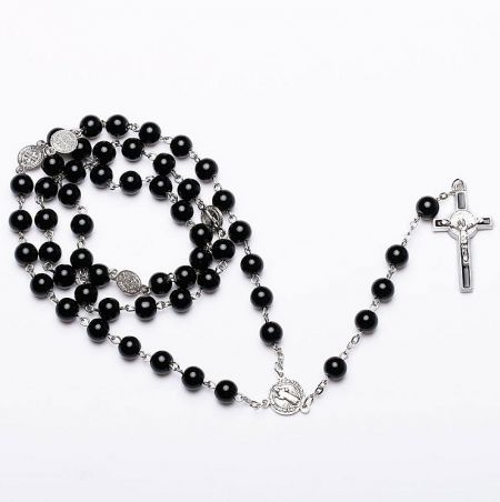 Detailed view of the black rosary with a silver crucifix.
