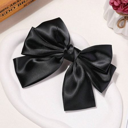 Another angle of the black satin bow, showing its texture.